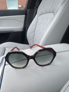 Fendi Tortoiseshell Round Women's Sunglasses with Red Temples.